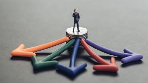 Boneco representando um homem com várias setas apontando direções ao redor